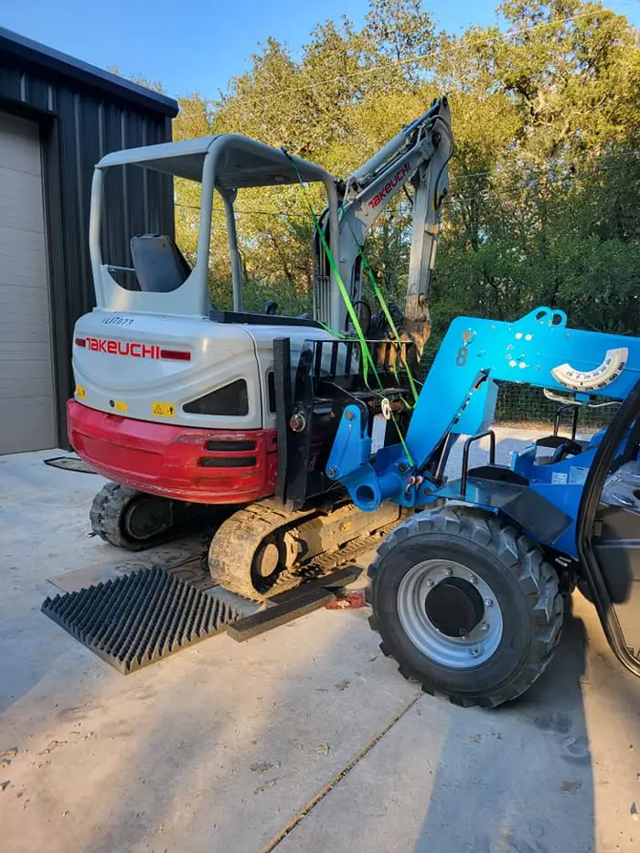 Compact mini-excavator loaded for mobile repair